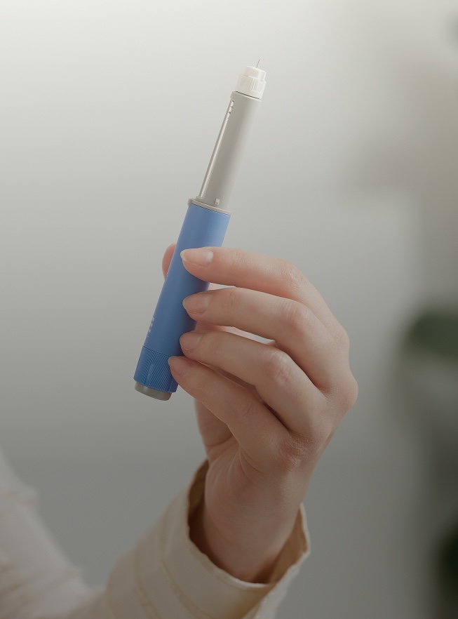Professional holding a injectable medication pen device