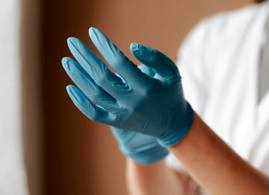 Professional putting on disposable gloves