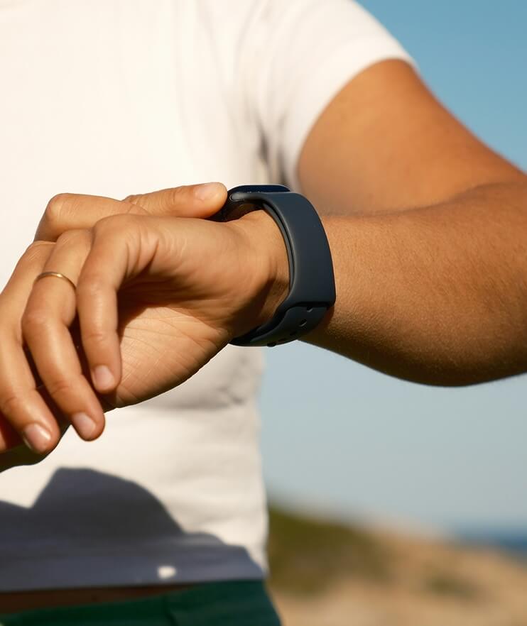 Person checking smart watch health metrics