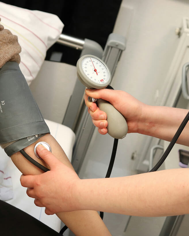 a healthcare professional measuring a patient's blood pressure