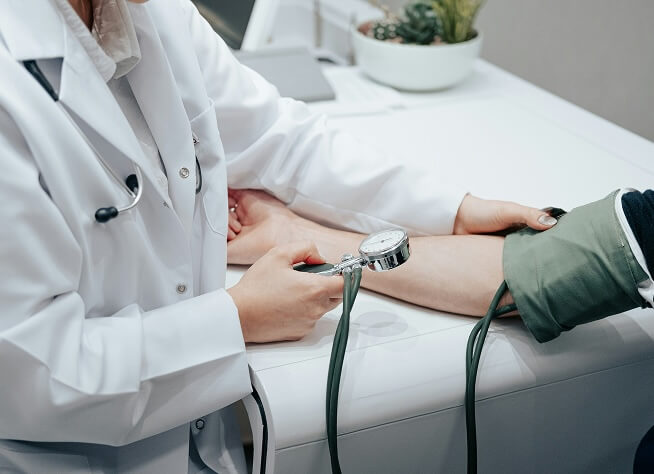 Professional measuring patient blood pressure