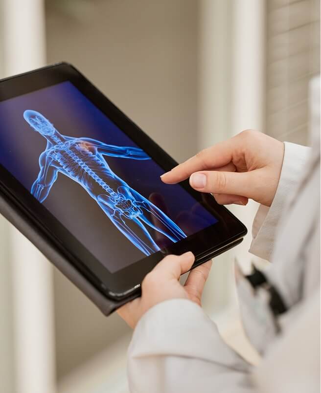 A healthcare professional using a digital tablet