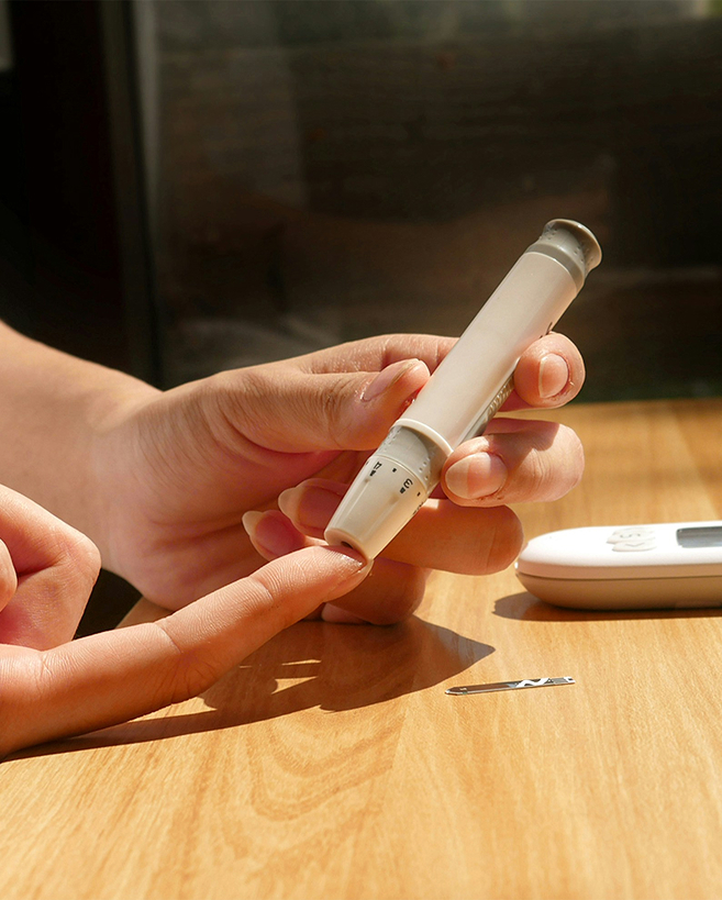 A person using a blood glucose monitor