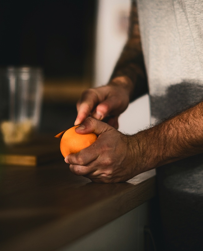 Man cutting orange