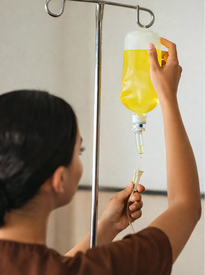 Medical professional checking IV bag