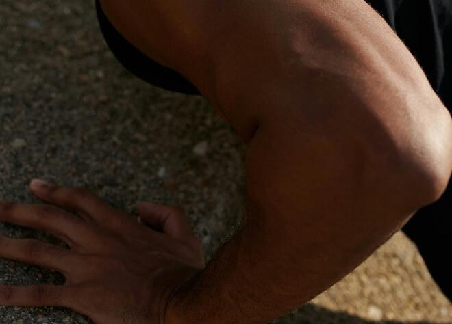 Close-up of man's elbow while doing a push-up