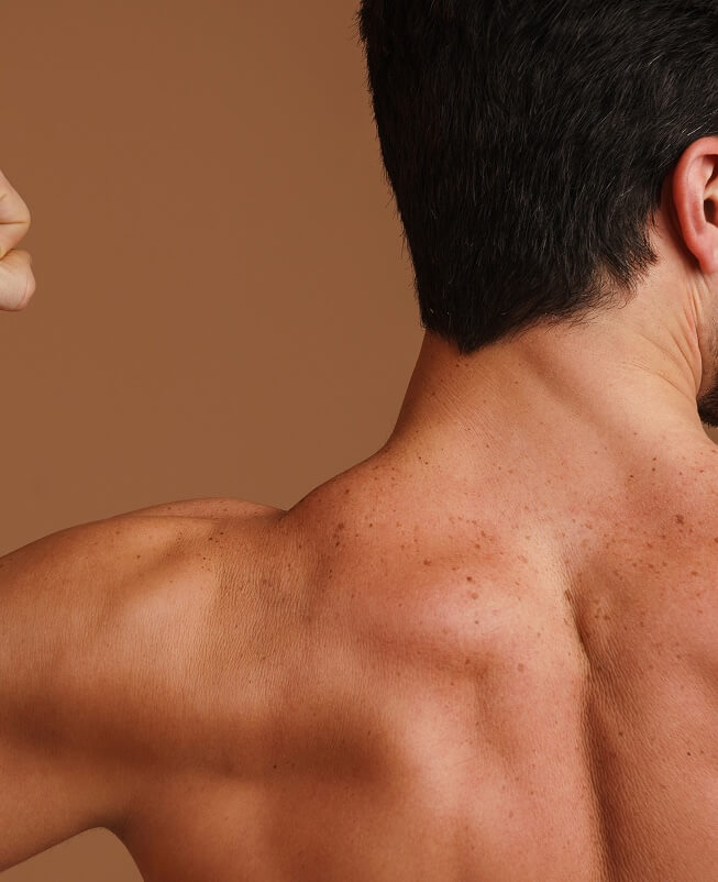 Close-up of man's back while he is flexing