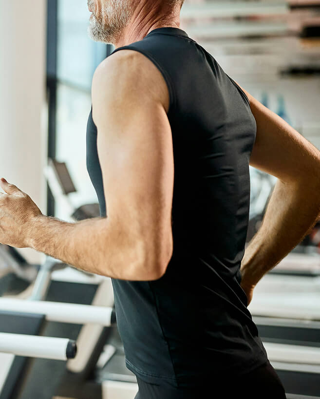 A mature athletic man running on a treadmill