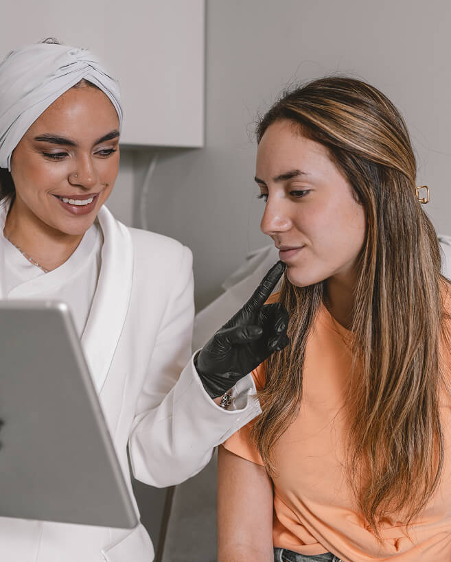 A consultation session between an esthetician and a client