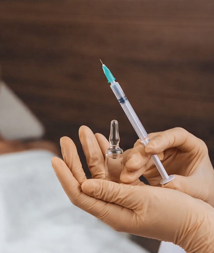 A medical injection kit with a syringe and a small vial