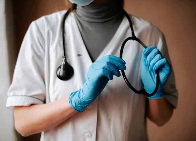 A healthcare professional holding a stethoscope