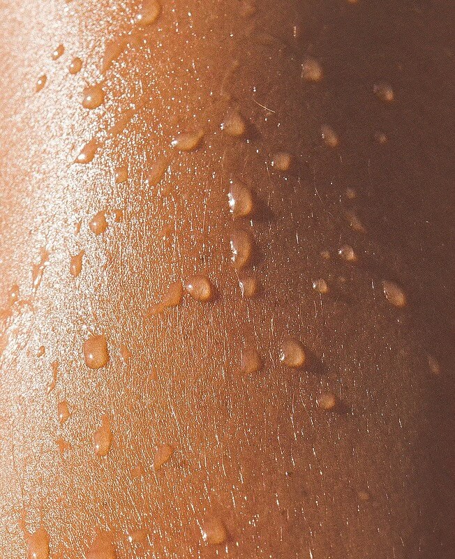 Close-up of water droplets on an arm