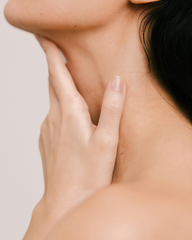 Person touching their neck area